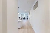 Located at 102 Hackett Blvd in Albany, NY, this thoughtfully designed 2-bedroom, 2-bathroom residence offers a bright, modern living experience across a single floor. The open-concept layout seamlessly connects the kitchen and living room, creating a spacious and cohesive common area. The living room is a standout, featuring soaring ceilings, elegant arched windows that flood the space with natural light, and light-toned hardwood flooring that runs throughout. The kitchen is well-appointed with crisp white shaker cabinetry, a striking marble-veined quartz waterfall island with an undermount sink, stainless steel appliances including a gas range and French door refrigerator, and stylish globe pendant lighting. Both bedrooms are comfortably sized, each with closet storage; the primary bedroom includes a dedicated wall-mounted HVAC unit for personalized climate control. The bathrooms feature clean, contemporary finishes, with one showcasing a glass-enclosed walk-in shower with classic white subway tile. A dedicated in-unit laundry room with a full-size washer and dryer adds everyday convenience. The overall aesthetic is clean, modern, and move-in ready.