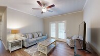This well-appointed two-bedroom, two-bathroom home in Florence, South Carolina, offers a comfortable and functional single-floor layout. Throughout the home, warm wood-style flooring and neutral tones create a cohesive, inviting atmosphere, complemented by crown molding and textured ceilings.

The living room serves as the heart of the home, featuring a ceiling fan with light fixture and French doors that open to the outdoors, filling the space with natural light. Adjacent to the living area, a dedicated dining space is highlighted by an elegant pendant chandelier. The kitchen features a peninsula with granite-style countertops, warm wood cabinetry, black appliances, and pendant lighting — all open to the dining area for easy everyday living.

A hallway leads to both bedrooms, each equipped with ceiling fans and ample natural light from windows. The spacious primary bedroom includes its own closet, while both bedrooms are well-served by two full bathrooms, each featuring a single vanity with rich wood cabinetry and a shower-tub combination.

A dedicated laundry room houses a full-size washer and dryer with overhead cabinetry for additional storage. Two closets throughout the home provide practical organization. This residence offers a complete, move-in-ready living experience in a clean, well-maintained setting.