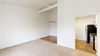 Located at 2807 Yulupa Ave in Santa Rosa, CA, this single-story, 2-bedroom, 1-bathroom home offers a well-organized layout across a comfortable footprint. The living area immediately captures attention with its vaulted, wood-paneled ceiling accented by exposed beams and a ceiling fan, creating an airy, open atmosphere. Flooring transitions between plush carpet in the living and bedroom areas and warm wood-look hardwood in the kitchen, dining, and bathroom spaces.

The kitchen is designed for functionality, featuring white cabinetry, dark countertops, a stainless steel sink, a dishwasher, and a full suite of appliances including a refrigerator and electric range. A pass-through counter connects the kitchen to the living and dining areas, enhancing the open-concept feel.

The spacious primary bedroom boasts soaring ceilings, dual sliding-door closets offering generous storage, and direct access to the full bathroom. The second bedroom benefits from a large sliding glass door that fills the room with natural light and provides outdoor views. The shared bathroom features a vanity with dark countertops, white cabinetry, and wood-look flooring. A hallway with additional storage connects the bedrooms and bathroom, completing this practical and comfortable home.