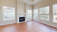 Located at 150 Du Rhu Dr in Mobile, Alabama, this two-bedroom, two-bathroom home spans two floors and offers a well-organized, functional layout. The main living level hosts the majority of the living space and features warm hardwood-style flooring throughout the common areas and bedrooms. The living room is bright and open, highlighted by a ceiling fan, crown molding, an elegant arched niche, and a large window that invites natural light. French doors lead to an outdoor access point, adding to the airy feel of the space. The kitchen is well-appointed with white cabinetry, a central island with pendant lighting, tile flooring, and a full suite of appliances. An adjacent dining area benefits from a bay window and additional French doors, creating a light-filled, welcoming atmosphere. The generously sized primary bedroom offers ample space with multiple windows and a ceiling fan. Both bathrooms feature tile flooring, white vanities with integrated sinks, and grab bars for added accessibility. A dedicated laundry area includes wire shelving and utility hookups. The attached garage provides built-in shelving and automatic door access. The home also includes multiple hallways, a closet, and two staircases connecting its levels efficiently.