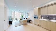 Located in the heart of Washington, DC, this single-floor residence at 1232 M St NW offers a refined modern living experience defined by clean lines, light-toned finishes, and an open, airy atmosphere. Light hardwood flooring flows seamlessly throughout, unifying each area of the space.

The open-concept living and dining area is a standout, anchored by dramatic floor-to-ceiling windows that flood the interior with natural light and offer sweeping views of the surrounding cityscape. The living area comfortably accommodates both a lounge and dining arrangement, with direct access to an outdoor balcony.

The kitchen is thoughtfully designed with flat-front light wood cabinetry extending to the ceiling, stainless steel Bosch appliances including a gas range, double wall ovens, and a sleek tile backsplash. Ample countertop and storage space make it as functional as it is visually appealing.

Two well-proportioned bedrooms provide comfortable retreats. The primary bedroom benefits from a large window with urban views, while the second bedroom offers a cozy, well-lit space. A bright hallway connects all areas, lined with louvered closet doors for added storage.

The bathroom features marble-look tile flooring, a glass-enclosed shower with metallic tile surround, and a light wood vanity with a clean white countertop, completing the space's cohesive contemporary aesthetic.