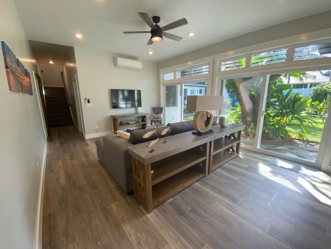 Living Room 1 (1st floor) - 14’ x 18’, sofa with chaise, coffee table, and 50” 4K smart television - 1543 Aalapapa Dr