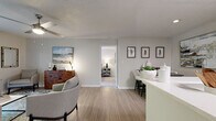 Located at 1701 Gander Cove Ln in Charlotte, NC, this single-floor residence offers a well-designed layout that balances functionality and comfort. The open-concept living area features light wood-look flooring, neutral walls, and a ceiling fan, creating a bright and airy atmosphere. A peninsula counter seamlessly connects the living space to the kitchen, which is outfitted with white shaker cabinetry, stainless steel appliances including a refrigerator, range, and over-the-range microwave, and a clean white countertop — ideal for both everyday cooking and entertaining.

The residence includes multiple bedrooms, each finished with plush carpet, ceiling fans, and windows that bring in natural light with views of greenery outside. The primary bedroom features a bold accent wall and ample space, while a second bedroom carries a mid-century modern character with decorative star wall accents and warm wood tones.

Two full bathrooms are finished with wood-look tile flooring, white vanity cabinetry, and clean white countertops. One bathroom includes a full tub-shower combination, while the other offers a compact, efficiently designed layout. Throughout the home, a cohesive neutral palette with textured ceilings and consistent trim work ties each room together into a polished, move-in-ready space.