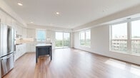 Located at 10010 6th Ave N in Plymouth, Minnesota, this well-appointed 3-bedroom, 2-bathroom single-floor residence offers a thoughtfully designed layout with modern finishes throughout. The open-concept kitchen and living area serves as the heart of the home, showcasing light hardwood-style flooring, recessed lighting, and white cabinetry with a contrasting center island. Stainless steel appliances add a polished touch, while a sliding glass door opens to a private balcony with expansive outdoor views. The living room features a fireplace flanked by built-in shelving and large windows that flood the space with natural light. Each bedroom is carpeted for comfort, with generous closet space including a walk-in closet outfitted with wire shelving systems. The bedrooms offer peaceful views of surrounding greenery and the cityscape beyond. The two bathrooms are finished cleanly in neutral tones, with one featuring a glass-enclosed walk-in shower with classic white subway tile. A connecting hallway ties the layout together seamlessly, creating an efficient and cohesive flow throughout the residence. The overall ambiance is clean, contemporary, and move-in ready.