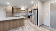 Located on Lovers Lane in Melrose, Minnesota, this one-bedroom, one-bathroom residence offers a thoughtfully designed, single-level layout that maximizes both function and comfort. Light-toned luxury vinyl plank flooring flows throughout the main living areas, complemented by a neutral color palette that creates a clean, modern aesthetic.

The kitchen is a standout feature, outfitted with warm wood cabinetry, granite-style countertops, and a full suite of stainless steel appliances including a refrigerator, electric range, microwave, and dishwasher. A peninsula island with matching countertop provides additional prep space and connects seamlessly to the open living area.

The living room is bright and inviting, anchored by a sliding glass door that opens to a private balcony overlooking the open Minnesota landscape — an ideal setting for enjoying expansive countryside views. Baseboard heating is present throughout the unit.

The bedroom is carpeted for comfort, features a window with natural views of the surrounding rural terrain, and is serviced by a dedicated closet. The bathroom includes a full tub-shower combination, a wood-vanity with white countertop, and consistent light-toned flooring. The overall layout is efficient, functional, and well-suited for comfortable single-occupant or couple living.