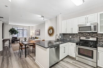 View from Kitchen Toward Bedroom, Dining Table, and Windowed Living Room - The Barton at Woodley