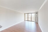 Located in the Dupont Circle neighborhood of Washington, DC, this efficiently designed unit at 2126 P St NW offers a thoughtful layout across a single floor. The living room serves as the heart of the space, featuring warm hardwood-style flooring, crisp white walls adorned with elegant crown molding, and floor-to-ceiling sliding glass doors that open to a private balcony. The balcony provides open views of the surrounding Washington cityscape, while also flooding the interior with abundant natural light.

The kitchen is equipped with warm-toned wood cabinetry, granite countertops, a textured tile backsplash, and a full suite of stainless steel appliances including a range, microwave, and dishwasher. A pass-through counter connects the kitchen to the living area, enhancing the open feel of the space.

A central hallway connects the key areas of the unit, leading to the bathroom and two well-sized closets that provide ample storage. The entrance opens conveniently into the living space, creating a welcoming flow throughout. Consistent hardwood-style flooring runs through the main areas, tying the interior together with a clean, cohesive aesthetic suited for comfortable urban living.