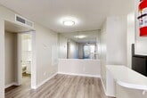 Located at 14531 Ella Blvd in Houston, TX, this one-bedroom, two-bathroom unit offers a thoughtfully organized single-floor layout that makes efficient use of its space. Light-toned wood-look flooring runs consistently throughout, complementing the neutral wall palette and white trim to create a clean, cohesive aesthetic.

The living room is bright and airy, featuring a ceiling fan and a sliding glass door that opens directly onto a private patio, allowing natural light to flow freely into the space. Adjacent to the living area, the combined dining room and kitchen is well-equipped with white cabinetry, light countertops, a stainless steel sink, and a black electric range with overhead ventilation — all supported by a dedicated pantry for additional storage.

The bedroom is comfortably sized, fitted with a ceiling fan and a window that brings in natural light. A dedicated closet provides organized storage space. The unit includes two full bathrooms, each featuring wood-look flooring, a tub-shower combination, vanity with sink, and classic white fixtures. A hallway connects the private areas of the unit, contributing to a functional and intuitive flow throughout the home.