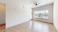 Located at 2220 Berryhill Road in Charlotte, NC, this well-appointed 2-bedroom, 2-bathroom residence offers a thoughtfully designed single-floor layout. The open-concept living, dining, and kitchen area serves as the heart of the home, featuring light wood-style flooring throughout, soaring ceilings, and generous windows that flood the space with natural light. A ceiling fan keeps the living area comfortable, while a sliding door leads to a private balcony with outdoor views.

The kitchen is a standout, anchored by a large quartz-topped island with an undermount sink and matte black faucet. Light wood cabinetry provides ample storage, while stainless steel appliances — including a range, microwave, and refrigerator — complete the modern look. Stylish pendant lighting hangs above the island, adding a contemporary touch.

Both bedrooms feature light wood flooring, bright windows with views of the surrounding greenery, and access to well-organized closets with wire shelving systems. The bathrooms are clean and functional, with one featuring a full tub-shower combination with subway tile surround and matte black fixtures. Additional conveniences include a dedicated laundry area and utility room, rounding out this move-in-ready Charlotte residence.