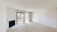 Located at 43032 30th St W in Lancaster, CA, this 2-bedroom, 2-bathroom single-floor residence offers a well-organized layout across a comfortable footprint. The living room serves as the heart of the home, featuring plush carpeting, a textured ceiling, a corner fireplace, and a sliding glass door that opens onto a private balcony, allowing natural light to fill the space. The dining area flows naturally from the living room, creating a cohesive open feel. The galley-style kitchen is thoughtfully updated with crisp white shaker cabinetry, light quartz countertops, wood-look vinyl flooring, recessed lighting, and stainless steel appliances including a gas range, microwave, and refrigerator. The spacious primary bedroom offers generous proportions with soft carpet, a ceiling fan, and access to a closet. The second bedroom features carpet flooring, a window with blinds, and a closet. Both bathrooms are finished with white vanity cabinetry and wood-look vinyl flooring. Additional highlights include multiple closets for storage, dedicated hallways, and an in-unit laundry area. The overall aesthetic is clean and neutral, presenting a move-in-ready home in a convenient Lancaster location.