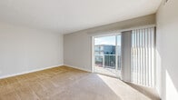 Located at 5142 N High St in Columbus, Ohio, this well-appointed 2-bedroom, 3-bathroom residence offers a thoughtfully designed single-floor layout. The bright and open living room is finished with plush carpeting and features a sliding glass door that leads to a private balcony, filling the space with natural light and outdoor views. The kitchen is equipped with warm wood cabinetry, granite countertops, and a full suite of stainless steel appliances including a refrigerator, dishwasher, gas range, and built-in microwave, all set over durable hardwood-style flooring. A pantry provides additional storage convenience. The hallway connects the living areas to the bedrooms, featuring a stylish sliding barn door. The generously sized primary bedroom includes access to a dedicated bathroom with granite-topped cabinetry and an adjacent walk-in closet. The second bedroom is carpeted and well-lit with a nearby window. All three bathrooms are finished with hardwood-style flooring and rich wood vanities with granite counters. Additional highlights include a dedicated laundry area, utility room, and multiple closets throughout. Neutral tones and clean finishes create a cohesive, move-in-ready ambiance throughout the space.