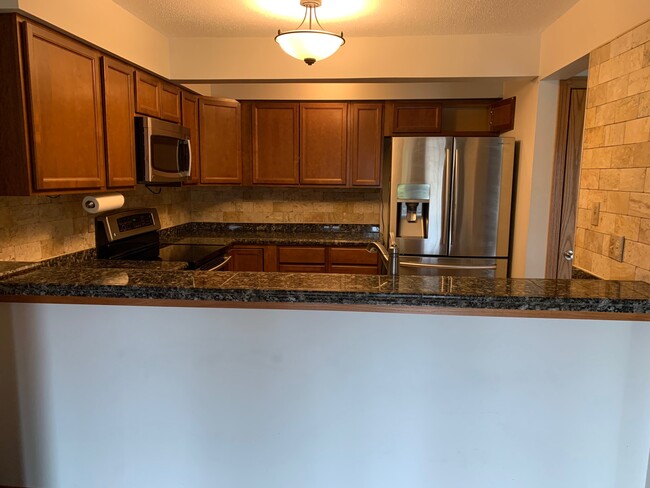 Kitchen from dining area - 8150 Shorewalk Dr