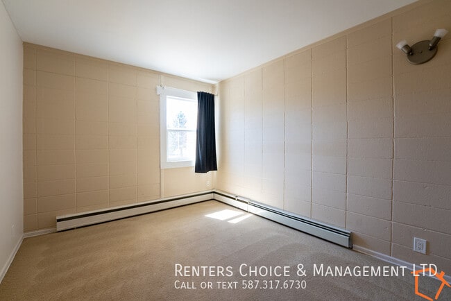 Building Photo - Main Floor Unit With Assigned parking and Utilities Included