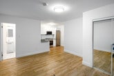 Located at 608 Church Street in the heart of Toronto's Church-Wellesley Village, Unit D9 is a thoughtfully renovated single-floor residence offering a clean, modern aesthetic throughout. Light-toned laminate hardwood flooring runs continuously across the space, creating a warm and cohesive feel from room to room.

The open-concept kitchen is a standout feature, outfitted with crisp white shaker-style cabinetry, dark grey quartz countertops, a stainless steel undermount sink, and a full suite of stainless steel appliances including a built-in oven, electric cooktop, over-the-range microwave, and refrigerator. A tiled backsplash adds a refined finishing touch.

The living area is bright and versatile, with a window overlooking the surrounding neighbourhood and a baseboard heating system along the perimeter. The bedroom offers a generous layout with windows on two sides, a mirrored sliding-door closet, and its own baseboard heating — providing both storage and natural light.

The bathroom is finished in an all-white palette, featuring a full-size soaker tub with an overhead shower, white subway tile surround, and chrome fixtures for a clean, polished look.

With its updated finishes and prime downtown Toronto location, Unit D9 offers a functional and stylish urban living experience.