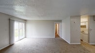Located at 850 Lindbergh Dr in Jackson, Mississippi, this single-floor unit offers a straightforward and functional layout designed for comfortable everyday living. The spacious main living area is finished with neutral-toned carpet and features a textured ceiling, clean white baseboards, and a large sliding glass door that fills the room with natural light while providing a view of the outdoors. The open feel of the living space is complemented by a hallway that connects to the rest of the unit.

The kitchen is efficiently designed with wood-look vinyl flooring, white cabinetry, a range with coil burners, an overhead ventilation hood, and a full-size refrigerator — providing all the essentials for daily meal preparation. Adjacent rooms include carpeted bedrooms, each offering neutral walls and windows that admit natural light, with one room featuring a sliding closet door for added storage.

The unit includes two bathrooms, each equipped with a tub-shower combination, toilet, and vanity. Both bathrooms feature wood-look vinyl flooring and textured walls, maintaining a clean and consistent aesthetic throughout. The overall interior palette of warm neutrals and white trim creates a simple, move-in-ready environment throughout the entire space.