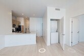 Located at 280 Fairmount Ave in Jersey City, NJ, this well-appointed 2-bedroom, 2-bathroom residence offers a thoughtfully designed single-floor layout with a clean, contemporary aesthetic throughout. Light wood-tone flooring flows continuously through the space, complementing the crisp white walls and modern finishes.

The combined kitchen and living area serves as the heart of the home, featuring a large center island with a white quartz countertop and an integrated sink. The kitchen is equipped with stainless steel appliances — including a gas range, microwave, dishwasher, and refrigerator — paired with wood-toned cabinetry and a subway tile backsplash. Bold black-framed windows flood the area with natural light and offer open views of the surrounding neighborhood.

Both bedrooms are well-sized, with the primary bedroom offering generous proportions. Each room benefits from the same large black-framed windows that define the unit's modern character. Each bedroom is served by its own dedicated closet for additional storage convenience.

The two bathrooms are finished in a clean, modern style. One features a glass-enclosed walk-in shower with white subway tile surround and light stone-toned floor tiles. The second bathroom includes a vanity with dark wood cabinetry. A dedicated laundry area completes this well-rounded residence.