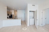 Located at 280 Fairmount Ave in Jersey City, NJ, this well-appointed 2-bedroom, 2-bathroom residence offers a thoughtfully designed single-floor layout with a clean, contemporary aesthetic throughout. Light wood-tone flooring flows continuously through the space, complementing the crisp white walls and modern finishes.

The combined kitchen and living area serves as the heart of the home, featuring a large center island with a white quartz countertop and an integrated sink. The kitchen is equipped with stainless steel appliances — including a gas range, microwave, dishwasher, and refrigerator — paired with wood-toned cabinetry and a subway tile backsplash. Bold black-framed windows flood the area with natural light and offer open views of the surrounding neighborhood.

Both bedrooms are well-sized, with the primary bedroom offering generous proportions. Each room benefits from the same large black-framed windows that define the unit's modern character. Each bedroom is served by its own dedicated closet for additional storage convenience.

The two bathrooms are finished in a clean, modern style. One features a glass-enclosed walk-in shower with white subway tile surround and light stone-toned floor tiles. The second bathroom includes a vanity with dark wood cabinetry. A dedicated laundry area completes this well-rounded residence.