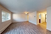 Located at 5900 Soundview Dr in Gig Harbor, WA, this single-floor, 2-bedroom, 1-bathroom residence offers a functional and well-appointed layout. The living room is a bright, open space highlighted by large sliding glass doors that open to a private patio, allowing abundant natural light to fill the room. A ceiling fan, textured ceiling, and hardwood-style laminate flooring complete the area, while a baseboard heating system runs throughout the main living spaces. The kitchen features warm-toned wood cabinetry, quartz countertops, stainless steel appliances including a refrigerator and range, and a dishwasher — offering both style and practicality. A hallway connects the main living area to the two bedrooms and bathroom. Both bedrooms are carpeted and offer a comfortable, quiet retreat, each with access to closet storage. The primary bedroom is a well-sized room with a window that brings in natural light. The full bathroom includes a vanity with quartz countertops, warm wood cabinetry, a tub-shower combination, and hardwood-style flooring. Two closets provide additional storage throughout the home. The overall ambiance is clean, updated, and move-in ready.