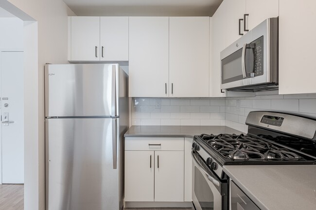 Sleek stainless steel appliances and modern cabinetry - Newport Rentals