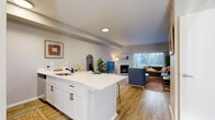 Located at 2718 Moorhead Ave in Boulder, CO, this well-appointed 2-bedroom, 2-bathroom residence offers a thoughtfully designed single-floor layout. The open-concept living and kitchen area serves as the heart of the home, featuring light wood-style flooring, neutral walls, and a cozy fireplace. Large sliding glass doors allow generous natural light to pour in and provide access to one of two private balconies. The kitchen is equipped with white shaker cabinetry, white quartz countertops, stainless steel appliances, and a peninsula with bar seating — ideal for casual dining and entertaining. The primary bedroom offers carpeted flooring, a closet, and a dedicated study area, while the second bedroom also features carpet, a sliding closet, and a bright window. Both bathrooms are finished with wood-style flooring, white vanity cabinetry, and full tub-shower combinations. Additional features include three closets for ample storage, two hallways connecting the layout efficiently, and a dedicated laundry area. The overall ambiance is clean, modern, and functional — well-suited for everyday living in a convenient Boulder location.