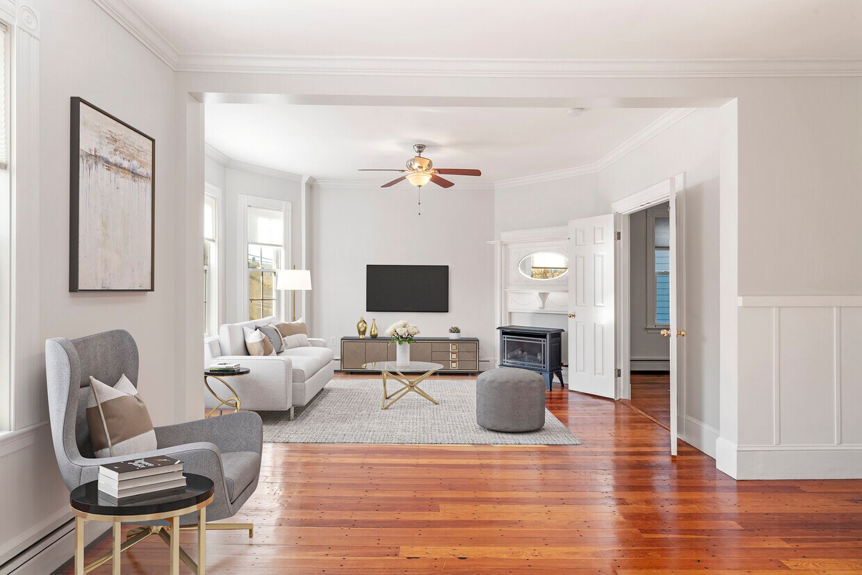 Living Room - Includes gas stove and an abundance of natural light. Connects to dining area. - 258 E Cottage St