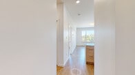 Located at 1085 Goldstream Ave in Langford, BC, this well-appointed one-bedroom, one-bathroom unit offers a thoughtfully designed layout across a single floor. The open-concept kitchen and living area serves as the heart of the home, featuring warm light wood laminate flooring that flows seamlessly throughout the space. The kitchen is equipped with contemporary flat-panel cabinetry in a soft wood-tone finish, a sleek peninsula with a light-coloured countertop, stainless steel appliances including a range and refrigerator, and recessed pot lighting overhead. The living area offers generous open space, complemented by clean white walls that enhance the sense of brightness. The bedroom is a comfortable, well-proportioned room bathed in natural light from a large window framing a scenic view of treetops and the surrounding Langford hills. A second window with a balcony view further connects the bedroom to the outdoors. The bathroom features a full soaker tub and shower combo with clean white surround and modern chrome fixtures. Additional spaces include a utility room, closet, and hallway, providing practical storage and circulation. Throughout the unit, the palette of crisp whites and natural wood tones creates a clean, modern, and welcoming ambiance.