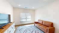 Located at 691 Union Chapel Rd in Cedar Creek, TX, this single-floor, 1-bedroom, 1-bathroom home offers a thoughtfully designed layout with modern finishes throughout. The open living area features light wood-style flooring, recessed lighting, and a bright window dressed with blinds that invites natural light into the space. The kitchen is a standout feature, equipped with crisp white cabinetry, granite countertops, stainless steel appliances including a refrigerator, electric range, and built-in microwave, plus a peninsula with pendant lighting and a stainless steel sink — ideal for both cooking and casual dining. The bedroom is a comfortable retreat with plush carpeting, a ceiling fan, a built-in desk nook with granite countertop, a window for natural light, and direct access to a dedicated closet with wire shelving. The bathroom is clean and functional, featuring a tub-shower combination, white cabinetry, granite countertops, and wood-style flooring. A separate laundry area with overhead wire shelving adds everyday convenience. The home's neutral color palette and modern design elements create a cohesive, move-in-ready ambiance throughout.