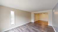 Located at 138 W Woodstock St in Crystal Lake, IL, this well-appointed one-bedroom, one-bathroom residence offers an efficient and comfortable single-floor layout. The living room is bright and welcoming, featuring cool-toned accent walls, durable gray vinyl plank flooring, and a sliding glass door that fills the space with natural light and provides direct access to the private patio. The adjoining dining room continues the open feel with warm wood-toned flooring and a seamless connection to the living area. The kitchen is thoughtfully designed with dark espresso cabinetry, granite-look countertops, stainless steel appliances, and matching vinyl plank flooring, offering a clean and modern aesthetic. The bedroom features plush carpeting, a six-panel door, a window for natural light, and generous closet space — with four closets distributed throughout the unit providing ample storage. The full bathroom includes a tub-shower combo with built-in shelving and brushed nickel fixtures. An in-unit laundry area adds everyday convenience. Neutral, warm beige walls throughout create a cohesive and move-in-ready environment, making this a practical and comfortable home in a residential Crystal Lake setting.
