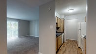 Located at 4101 Brett St in Corpus Christi, Texas, this single-floor unit offers a practical and comfortable layout designed for everyday living. The living area welcomes you through a front entry door and features neutral-toned carpet, soft gray walls, and a pass-through window that connects seamlessly to the kitchen — a classic detail that enhances the open feel between the two spaces. A sliding glass door in the living area allows natural light to pour in and provides access to the outdoors.

The kitchen is efficiently designed with warm wood-toned cabinetry, dark countertops, wood-look plank flooring, and white appliances including a refrigerator, range, and dishwasher. A dedicated pantry or utility area is accessible directly from the kitchen.

The bedrooms are generously sized, each finished with plush carpet and neutral gray walls. One bedroom features a large window that fills the room with natural light, while another offers a sliding glass door. Both rooms provide a calm and versatile environment.

The bathroom is finished with wood-look flooring, a wood-toned vanity with dark countertop, a mirrored medicine cabinet, and a full tub-shower combination with tiled surround. The overall aesthetic throughout the unit is clean, neutral, and move-in ready.
