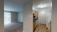 Located at 4101 Brett St in Corpus Christi, Texas, this single-floor unit offers a practical and comfortable layout designed for everyday living. The living area welcomes you through a front entry door and features neutral-toned carpet, soft gray walls, and a pass-through window that connects seamlessly to the kitchen — a classic detail that enhances the open feel between the two spaces. A sliding glass door in the living area allows natural light to pour in and provides access to the outdoors.

The kitchen is efficiently designed with warm wood-toned cabinetry, dark countertops, wood-look plank flooring, and white appliances including a refrigerator, range, and dishwasher. A dedicated pantry or utility area is accessible directly from the kitchen.

The bedrooms are generously sized, each finished with plush carpet and neutral gray walls. One bedroom features a large window that fills the room with natural light, while another offers a sliding glass door. Both rooms provide a calm and versatile environment.

The bathroom is finished with wood-look flooring, a wood-toned vanity with dark countertop, a mirrored medicine cabinet, and a full tub-shower combination with tiled surround. The overall aesthetic throughout the unit is clean, neutral, and move-in ready.