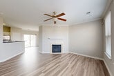 Located at 508 Pride Avenue in Herndon, Virginia, this three-bedroom, two-bathroom home spans three floors, offering a well-organized and functional layout. The entry level provides a welcoming entrance with access to the upper floors via carpeted staircases. The main living floor serves as the heart of the home, featuring an open-concept living and dining area adorned with crown molding, a ceiling fan, and a fireplace with a tile surround — complemented by light-toned hardwood-style flooring throughout. Sliding glass doors lead to an outdoor deck, bringing in natural light and outdoor access. The kitchen is equipped with white shaker cabinetry, dark countertops, stainless steel appliances including a gas range, microwave, and refrigerator, along with a peninsula island ideal for casual dining. A pantry provides additional storage. The upper floor houses all three bedrooms, including a generously sized primary bedroom with multiple windows offering neighborhood views. The bedrooms feature hardwood-style flooring and ample closet space. Two full bathrooms serve the home, each finished with white vanities and tub-shower combinations. The neutral color palette and clean finishes throughout give the home a bright, move-in-ready feel.