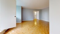 Located at 66 High St E in Mississauga, Ontario, this one-bedroom, one-bathroom unit offers a well-organized layout across a single floor. The space is defined by its warm, classic parquet wood flooring, which runs throughout the living, dining, and bedroom areas, lending a timeless character to the interior.

The living and dining areas are open and airy, benefiting from large floor-to-ceiling windows that invite abundant natural light and offer views of the surrounding neighbourhood's greenery. A pendant chandelier adds a decorative touch to the dining area. Baseboard heating runs along the window walls, ensuring year-round comfort.

The bedroom is a comfortable, well-proportioned space with the same parquet flooring and easy access to the rest of the unit. A dedicated closet with built-in shelving provides practical storage.

The kitchen features white cabinetry, white tile flooring, and includes a coil-top electric range. It connects conveniently to the unit's entrance, streamlining daily comings and goings. A hallway connects the main spaces to the full bathroom, which is finished with clean white ceramic wall tiles and includes a bathtub with a shower.

The entrance foyer provides a welcoming transition into the unit, completing a functional and cohesive floor plan suited for comfortable single-occupancy living.