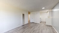 Located at 17341 Hurley St in La Puente, CA, this single-story, one-bedroom, one-bathroom unit offers a clean and functional layout with consistent light wood-style flooring throughout. The combined living and dining area serves as the heart of the home, featuring neutral white walls, a textured ceiling, a wall-mounted HVAC vent, and a window unit for additional climate control. Vertical blinds allow for adjustable natural light, creating a bright and airy atmosphere. A hallway connects the main living space to the private areas of the unit. The bedroom is a comfortable, well-proportioned room accented with a ceiling fan and light fixture, a window with vertical blinds for natural light, and a sliding closet with paneled doors. A soft blue accent wall adds a subtle touch of character. The bathroom is clean and straightforward, featuring light wood-style tile flooring, a white vanity with cabinet storage and a mirrored medicine cabinet, and a bathtub. Three closets throughout the unit provide ample storage. The kitchen includes a white gas range. The overall aesthetic is fresh, minimal, and move-in ready, with a cohesive neutral palette that creates a calm, functional living environment.