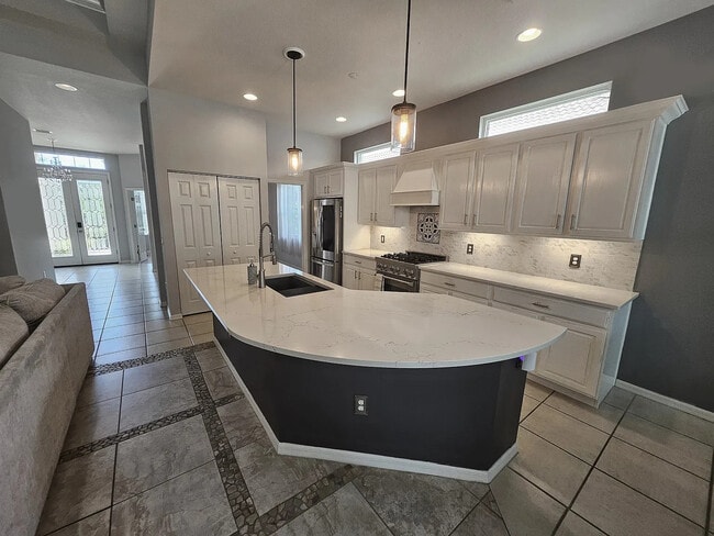 Custom renovated kitchen with a curved quartz countertop and new appliances - 4353 Reflections Pky House