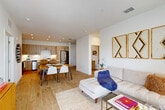 Located at 12000 Bryonia Rd in Orlando, FL, this well-appointed 2-bedroom, 2-bathroom residence offers a thoughtfully designed single-floor layout. The open-concept living, dining, and kitchen area serves as the heart of the home, filled with natural light from large windows dressed in sheer curtains. Light wood-tone flooring flows throughout the main living spaces, enhancing the bright and airy atmosphere.

The contemporary kitchen is a standout feature, showcasing warm wood cabinetry extending to the ceiling, white quartz countertops, a central island with bar seating, and a full suite of stainless steel appliances. The living area offers a comfortable retreat with recessed lighting and views that extend to a private balcony overlooking lush landscaping and a tranquil pond.

Both bedrooms are well-proportioned and finished with plush carpet, ceiling fans, and generous natural light. The primary bedroom connects to an en-suite bathroom featuring a floating wood vanity, white countertops, a walk-in glass shower, and light wood-style flooring. The second bathroom includes a soaking tub with tiled surround and matching cabinetry. Additional conveniences include two closets, a dedicated laundry area, and an entrance foyer. The private balcony completes this residence with serene outdoor views.