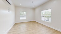 Located in Sacramento's desirable 95816 zip code, this well-designed one-bedroom, one-bathroom unit offers a thoughtfully efficient layout with contemporary finishes throughout. Light wood-style luxury vinyl plank flooring runs continuously across the entire space, creating a cohesive and clean aesthetic.

The open-concept living and kitchen area forms the heart of the unit. The kitchen is well-appointed with white shaker upper cabinets, warm wood-toned lower cabinets, light quartz countertops, and a full suite of stainless steel appliances including a refrigerator, electric range, built-in microwave, and dishwasher. Recessed lighting and a ductless mini-split system provide consistent comfort throughout this area. A window brings in natural light, enhancing the open feel of the space.

The living area is generously sized with multiple windows offering views of surrounding greenery, filling the room with natural light. The bedroom features a mirrored sliding closet and its own mini-split unit for independent climate control.

The bathroom is finished with large-format gray tile flooring, a walk-in glass-enclosed shower, a white vanity with a backlit LED mirror, and recessed storage. An in-unit stacked washer and dryer complete this practical, move-in ready space.