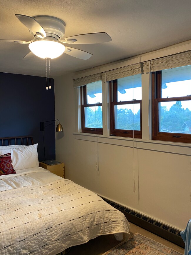 Cozy bedroom, with wall of windows for light, walk-in closet, lovely sunset views, ceiling fan, shades included - 340 NE Beyrl Ter