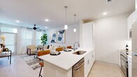 Located at 4840 N Shepherd Dr in Houston's 77018 zip code, this single-story residence offers a clean, contemporary design with an open-concept floor plan that seamlessly connects the kitchen, dining, and living areas. The kitchen is outfitted with white shaker cabinetry, quartz countertops, stainless steel appliances—including a refrigerator, range, and built-in microwave—and a central island with pendant lighting and bar seating. The living area features light wood-style flooring, recessed lighting, a ceiling fan, and windows that invite natural light throughout the space. The bedroom is generously proportioned, accommodating a full-size bed with room to spare, and is highlighted by multiple windows, sheer curtains, and a ceiling fan for comfort. A second bedroom provides additional flexibility. The bathroom presents a dual-sink vanity with white cabinetry, quartz countertops, a large mirror, and tile flooring, complemented by ample built-in storage. Throughout the unit, a neutral color palette of whites and soft beiges creates a bright, cohesive ambiance. Light wood-style flooring runs consistently through the main living areas, tying the space together with a modern yet warm aesthetic.