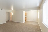Located at 537 Bellwood Rd in Newport News, Virginia, this single-floor residence offers a practical and comfortable layout designed for everyday living. The kitchen is equipped with light wood cabinetry, a double stainless steel sink, laminate countertops, and a white electric range, all set atop durable wood-look flooring that extends through the functional areas of the home. Adjacent to the kitchen, the open living area features neutral beige carpeting and connects seamlessly to the rest of the unit, creating a cohesive and easy-to-navigate floor plan. The bedrooms are generously sized, each finished with soft wall-to-wall carpeting and bright, neutral-toned walls. Natural light filters in through windows fitted with blinds, lending an airy feel to the sleeping quarters. At least one bedroom includes a dedicated closet with a rod and shelf for organized storage. The bathroom is well-appointed with a full tub and shower combo, a white vanity with an integrated sink, and wood-look flooring that ties in with the rest of the home. Throughout the residence, clean white trim, neutral wall tones, and consistent finishes create a cohesive and move-in-ready aesthetic.