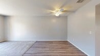 Located at 2700 Iowa Ave in Riverside, CA, this single-floor, one-bedroom, one-bathroom residence offers a well-organized layout designed for comfortable everyday living. The combined living and dining area is a highlight of the home, featuring wood-look luxury vinyl flooring that transitions seamlessly to plush carpeting, neutral gray walls, and a ceiling fan with integrated lighting. Sliding glass doors open directly onto a private balcony, bringing in natural light and outdoor views. The kitchen is efficiently designed with white cabinetry, light countertops, and stainless steel appliances including a gas range, over-the-range microwave, and refrigerator, all set over warm wood-look flooring. The spacious bedroom features soft carpeting, a window with exterior views, and direct access to a dedicated closet as well as the full bathroom. The bathroom is clean and functional, offering a combined shower and tub with chrome fixtures and white finishes. A hallway connects the living spaces, adding to the home's practical flow. Neutral tones and consistent finishes throughout give the residence a cohesive, move-in-ready feel.