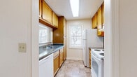 Located at 9709 E Jewell Ave in Aurora, CO, this one-bedroom, one-bathroom unit offers a functional and comfortable single-floor layout. The galley-style kitchen is well-equipped with warm oak cabinetry, dark laminate countertops, white appliances including an electric range, dishwasher, and refrigerator, plus tile flooring and multiple windows that bring in natural light. The spacious living room features soft carpeting, a textured ceiling, and a charming bay window arrangement that fills the room with light and offers outdoor views. A pass-through connects the kitchen to the living area, enhancing the open feel. The generously sized bedroom is carpeted and includes a window with natural light, ample closet storage, and ceiling ventilation. The bathroom features tile flooring, an oak vanity with a wide mirror, and a clean tub/shower combo with brushed nickel fixtures. A dedicated in-unit laundry area accommodates a full-size washer and dryer. Additional highlights include three closets for ample storage, two hallways for easy navigation, and a private balcony accessible from the unit. The overall ambiance is bright, neutral, and move-in ready.