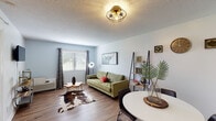 Located at 500 E Hargett St in the heart of Raleigh, NC, this single-floor residence offers a thoughtfully designed layout with a cohesive, modern aesthetic throughout. Wood-look flooring flows seamlessly across all rooms, tying the space together with warmth and consistency.

The open living and dining area serves as the heart of the home, bathed in natural light from a large window dressed with grommet curtains. A distinctive cage-style flush-mount ceiling light adds a modern touch overhead, while the space comfortably accommodates both a seating area and a dining set with room to spare.

The kitchen features butcher block countertops, a stainless steel sink, and a striking herringbone white tile backsplash, complemented by open shelving for practical storage and display.

The bedroom is a calm, comfortable retreat, featuring a window with outdoor views, a textured ceiling, and direct access to a closet and the full bathroom. An additional closet near the dining area provides extra storage convenience.

The full bathroom is clean and functional, featuring a tiled tub and shower combination, a vanity with storage, and the same warm wood-look flooring found throughout the unit.

Overall, this residence delivers a well-balanced blend of practicality and contemporary style in a prime downtown Raleigh location.