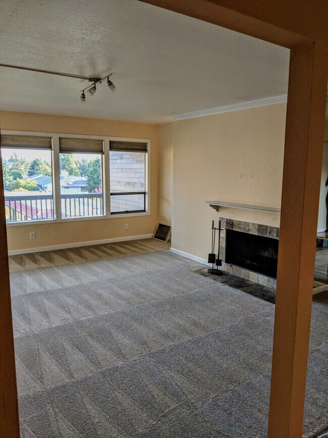 Living room with fireplace and view out to Lake Washington - 11640 100th Ave NE