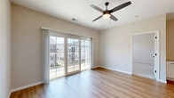 Located at 4985 Warner Rd. in Westerville, Ohio, this one-bedroom, one-bathroom unit offers a well-designed single-floor layout that maximizes both comfort and functionality. The open-concept living area is finished with warm hardwood-style flooring and features a ceiling fan with light fixture. Large sliding glass doors flood the space with natural light and open directly onto a private outdoor balcony with neighborhood views, creating a seamless indoor-outdoor connection. The kitchen is a standout feature, showcasing granite countertops, crisp white cabinetry extending to the ceiling, stainless steel appliances including a French door refrigerator and dishwasher, a beverage cooler, an undermount sink with a matte black faucet, and stylish pendant lighting above the peninsula island. The bedroom is carpeted for comfort and includes multiple windows fitted with blinds, allowing for ample natural light and pleasant exterior views. A dedicated closet provides additional storage. The bathroom is well-appointed with a granite-topped vanity, wood-toned cabinetry, a tile-surround walk-in shower with a frameless glass door, and hardwood-style flooring. The unit also includes a dedicated laundry area and utility room, rounding out a practical and polished living space.