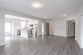 Located at 36 S New York Rd in Galloway, NJ, this single-floor residence offers a clean, modern aesthetic throughout. Consistent light-toned luxury vinyl plank flooring runs seamlessly across all living spaces, complemented by neutral wall colors that create a bright and cohesive atmosphere. A central hallway with gray-paneled doors connects the home's key spaces, providing an organized and functional layout. The kitchen is well-appointed with white shaker-style cabinetry, quartz countertops, a subway tile backsplash, stainless steel appliances including a gas range, microwave, and refrigerator, plus a center island with pendant lighting and a window above the sink for natural light. The bedrooms are generously sized, each featuring large windows with blinds that invite ample sunlight. One bedroom includes a walk-in closet with built-in shelving for convenient storage. The primary bathroom is finished with marble-look tile flooring and a glass-enclosed tiled shower, while a second full bathroom offers matching marble-style tile and a tub-shower combination with chrome fixtures and a vanity. The 3D floorplan reveals a well-structured, efficiently designed layout that maximizes comfort and livability throughout the single-floor home.
