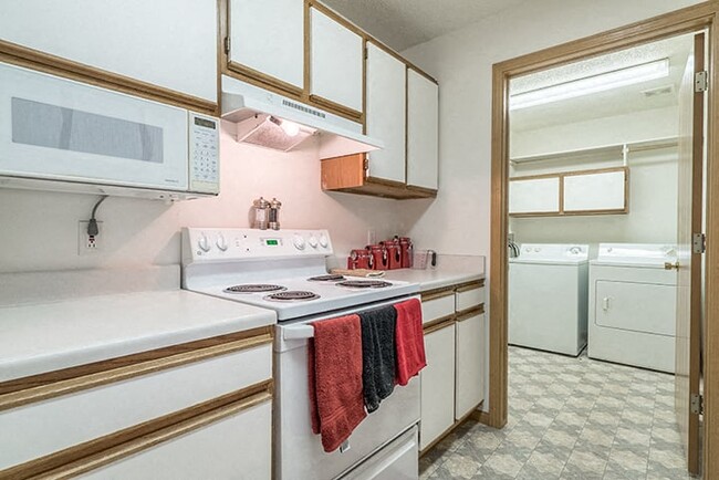 Several floor plans have laundry rooms located right off the kitchen. - Northbrook Apartments