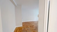 Located at 291 Avenue Rd in Toronto's desirable Summerhill neighbourhood, this one-bedroom, one-bathroom unit offers an efficiently designed layout across a single floor. The generously sized bedroom is the heart of the unit, featuring warm parquet hardwood flooring and a large window that fills the space with natural light, creating a bright and airy atmosphere. White walls throughout contribute to a clean, neutral palette that enhances the sense of openness. The kitchen is thoughtfully appointed with crisp white shaker-style cabinetry, marble-veined countertops, a subway tile backsplash, and a stainless steel sink — offering a modern and functional cooking space. The full bathroom is finished in a clean, all-white scheme with large-format floor tiles, a tiled tub-and-shower combination with a curved curtain rod, a toilet, and a vanity with a marble-style countertop. A hallway connects the rooms and provides entry to the unit. The consistent use of parquet hardwood flooring across the main living areas ties the space together, giving it a cohesive and classic character well-suited to urban living in one of Toronto's most sought-after neighbourhoods.