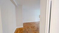 Located at 291 Avenue Rd in Toronto's desirable Summerhill neighbourhood, this one-bedroom, one-bathroom unit offers an efficiently designed layout across a single floor. The generously sized bedroom is the heart of the unit, featuring warm parquet hardwood flooring and a large window that fills the space with natural light, creating a bright and airy atmosphere. White walls throughout contribute to a clean, neutral palette that enhances the sense of openness. The kitchen is thoughtfully appointed with crisp white shaker-style cabinetry, marble-veined countertops, a subway tile backsplash, and a stainless steel sink — offering a modern and functional cooking space. The full bathroom is finished in a clean, all-white scheme with large-format floor tiles, a tiled tub-and-shower combination with a curved curtain rod, a toilet, and a vanity with a marble-style countertop. A hallway connects the rooms and provides entry to the unit. The consistent use of parquet hardwood flooring across the main living areas ties the space together, giving it a cohesive and classic character well-suited to urban living in one of Toronto's most sought-after neighbourhoods.