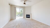 Located in Rocklin, CA, this single-floor, 3-bedroom, 3-bathroom home offers a well-designed layout with a bright and neutral aesthetic throughout. The open living room is a standout space, featuring a corner fireplace, a ceiling fan, and a sliding glass door that opens to a private balcony with outdoor views — filling the room with natural light and creating a welcoming atmosphere. Soft carpeting flows throughout the living areas and bedrooms.

The kitchen is efficiently appointed with light maple cabinetry, granite-look countertops, light hardwood-style flooring, and a full suite of stainless steel appliances including a gas range, microwave, dishwasher, and refrigerator. The layout connects seamlessly to the living area for easy everyday functionality.

Each of the three bedrooms offers a calm, neutral palette with plush carpet underfoot. One bedroom benefits from a large window with a pleasant outdoor view and abundant natural light. The primary bedroom includes access to a spacious walk-in closet with built-in shelving and hanging rods for generous storage.

The bathrooms are finished with warm wood-tone vanity cabinetry, white countertops, and well-lit mirrors. One bathroom features a soaking tub with a tiled surround. The home's clean, consistent finishes and practical layout make it a comfortable and functional residence.