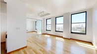 Located on the 7th floor at 541 S Spring St in the heart of Downtown Los Angeles, this one-bedroom residence offers a well-considered layout with a clean, modern aesthetic throughout. Light-toned hardwood flooring runs across the living area and bedroom, lending warmth and continuity to the space.

The open living room is bright and airy, with large black-framed windows that frame sweeping city views and flood the interior with natural sunlight. A frosted glass sliding door and warm wood-framed French doors add architectural character while providing flexible room separation.

The kitchen is efficiently designed with warm wood cabinetry featuring glass-panel upper doors, granite countertops, stone tile flooring, and a full suite of stainless steel appliances including a refrigerator, electric range, built-in microwave, and dishwasher.

The spacious bedroom is a standout feature, accommodating a generous furniture arrangement with ease. It benefits from the same large black-framed windows as the living area, offering continued city views and an abundance of natural light.

The overall ambiance is bright, clean, and contemporary — well-suited for urban living in one of Downtown LA's most vibrant and walkable neighborhoods.